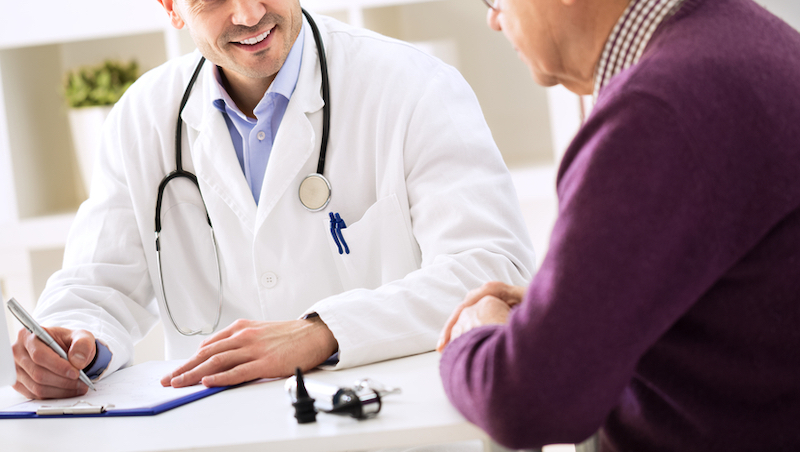 Doctor talking to patient and taking notes