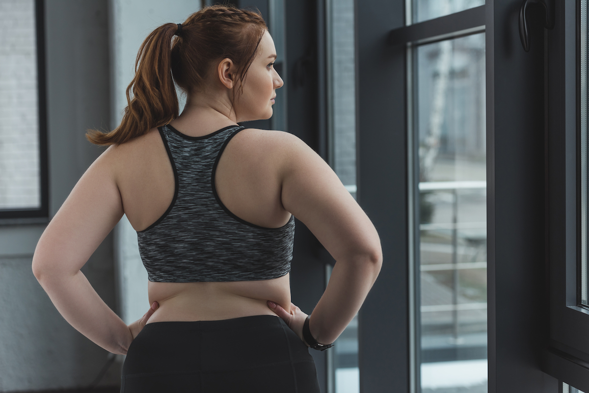 Woman in sports bra with her hands on her hips